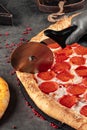 Cutting giant pepperoni pizza with special knife Royalty Free Stock Photo