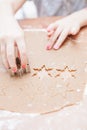 Cutting gingerbread shapes from dough Royalty Free Stock Photo