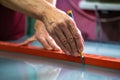 Cutting glass with a special tool. Glass cutter. A master in the workshop cuts glass according to the customer's dimensions. Royalty Free Stock Photo