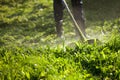 Cutting the grass trimmer. Man mowing grass on his land. Royalty Free Stock Photo