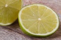 Cutting in half a fresh lime on a background of the old wooden Royalty Free Stock Photo