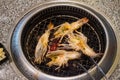 Cutting half grilled giant river prawn on stove Royalty Free Stock Photo