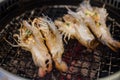 Cutting half river shrimp, and prawn barbecue over red hot charcoal stove Royalty Free Stock Photo