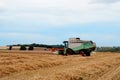 Cutting hay the combine on field  in the summertime Royalty Free Stock Photo