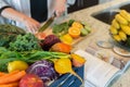 Cutting healthy fruits and vegetables for a recipe Royalty Free Stock Photo