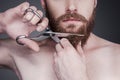 Cutting his perfect beard.