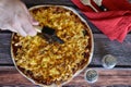 Cutting homemade pizza on slices with special knife. Royalty Free Stock Photo