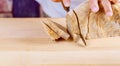 Cutting Homemade whole wheat and grain bread with knife bread, slices loaf on wooden board background. Royalty Free Stock Photo