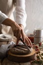 Cutting a jam Tart on a chopping board