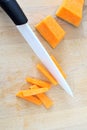 Cutting in julienne a pumpkin with a ceramic knife, from above, Royalty Free Stock Photo