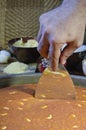 Cutting Kunafa or Kinafa, Arabic Sweets with Cheese for Ramadan a
