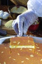 Cutting Kunafa or Kinafa, Arabic Sweets with Cheese for Ramadan a