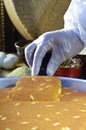 Cutting Kunafa or Kinafa, Arabic Sweets with Cheese for Ramadan a