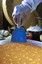 Cutting Kunafa or Kinafa, Arabic Sweets with Cheese for Ramadan a