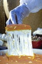 Cutting Kunafa or Kinafa, Arabic Sweets with Cheese for Ramadan a