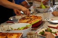 Cutting the lasagna during family meal