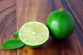 Cutting limes on wood. Royalty Free Stock Photo