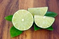 Cutting limes on wood. Royalty Free Stock Photo