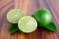 Cutting limes on wood. Royalty Free Stock Photo