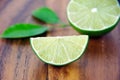 Cutting limes on wood. Royalty Free Stock Photo