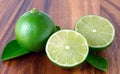 Cutting limes on wood. Royalty Free Stock Photo