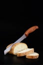 Cutting loaf of bread with knife on cutting board Royalty Free Stock Photo