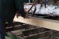 Wood processing. Cutting logs on the boards. In the winter process a tree