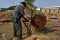 Cutting logs into firewood on a steam powered saw Royalty Free Stock Photo