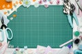 The cutting mat is surrounded by paper flowers, paper, tools and scrapbooking materials Royalty Free Stock Photo