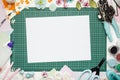 The cutting mat is surrounded by paper flowers, paper, tools and scrapbooking materials Royalty Free Stock Photo