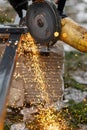 Cutting metal with angle grinder machine. Close up of circular grinder disc and electric sparks. Workers making fence with Royalty Free Stock Photo