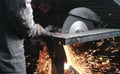 Cutting of metal. Closeup men`s hands cutting metal with a circular saw. Sparks fly to the side. Royalty Free Stock Photo