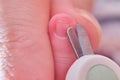 Cutting nails with special scissors on the fingers of a newborn baby, children manicure and cutting burrs Royalty Free Stock Photo