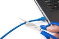 Cutting a network cable connected to laptop Royalty Free Stock Photo