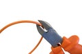 Cutting orange wire by nippers, cropping the cable under voltage Royalty Free Stock Photo