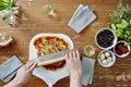 Cutting organic pizza with pizza knife Royalty Free Stock Photo