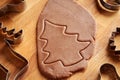 Cutting out tree shapes to prepare gingerbread Christmas cookies Royalty Free Stock Photo