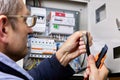 Cutting over sheath of power cable using retractable utility knife, electrician cuts outer sheath of high-voltage cable. Royalty Free Stock Photo