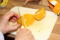 Cutting a peeled orange with sharp knife