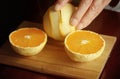 Cutting peeled oranges in two halves