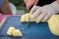 cutting peeled pineapple