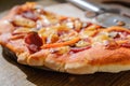 Cutting pepperoni pizza on slices with special knife Royalty Free Stock Photo