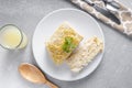 Cutting a piece of chilled savory chicken pie, a typical Brazilian dish. In red shape, gray wooden background. Next to a white