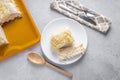 Cutting a piece of chilled savory chicken pie, a typical Brazilian dish. In red shape, gray wooden background. Beside white plate Royalty Free Stock Photo