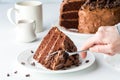 Cutting into a piece of moist homemade low sugar chocolate cake with a fork.