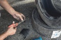 Cutting a piece of rubber to be used to patch the punctured inner liner of a tire. Vulcanizing procedure