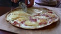 Cutting pizza slow motion view, alsacien special food