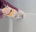 Cutting plasterboard plaster hand dirty saw Royalty Free Stock Photo