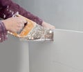 Cutting plasterboard plaster hand dirty saw