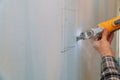 Cutting plasterboard plaster hand with electro saw